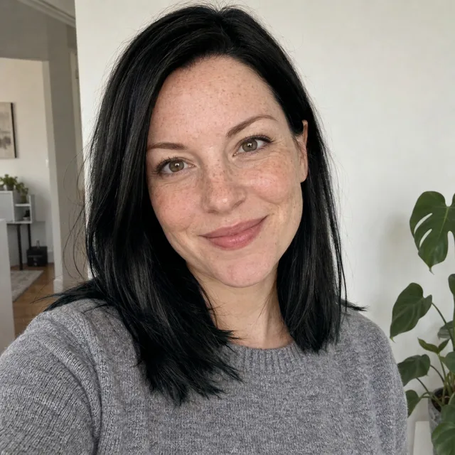 The same woman with glossy jet-black hair in the same cut