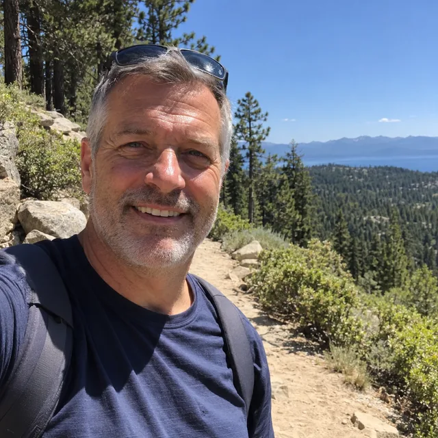 Synthetic source photo: a fictional grey-haired man on a hiking trail in hard midday sun, sunglasses on his head and backpack straps