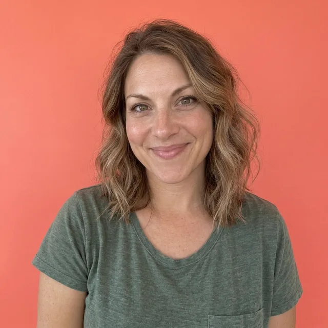 The same woman on a plain coral background, head and shoulders, centred
