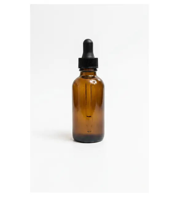 Original photo: amber dropper bottle on a plain white background