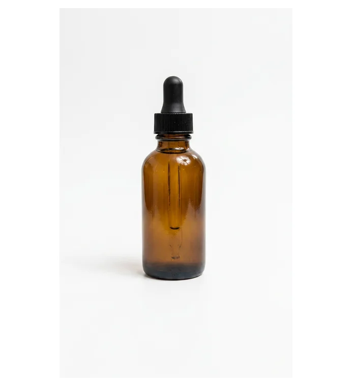 Amber dropper bottle photographed against a plain light background